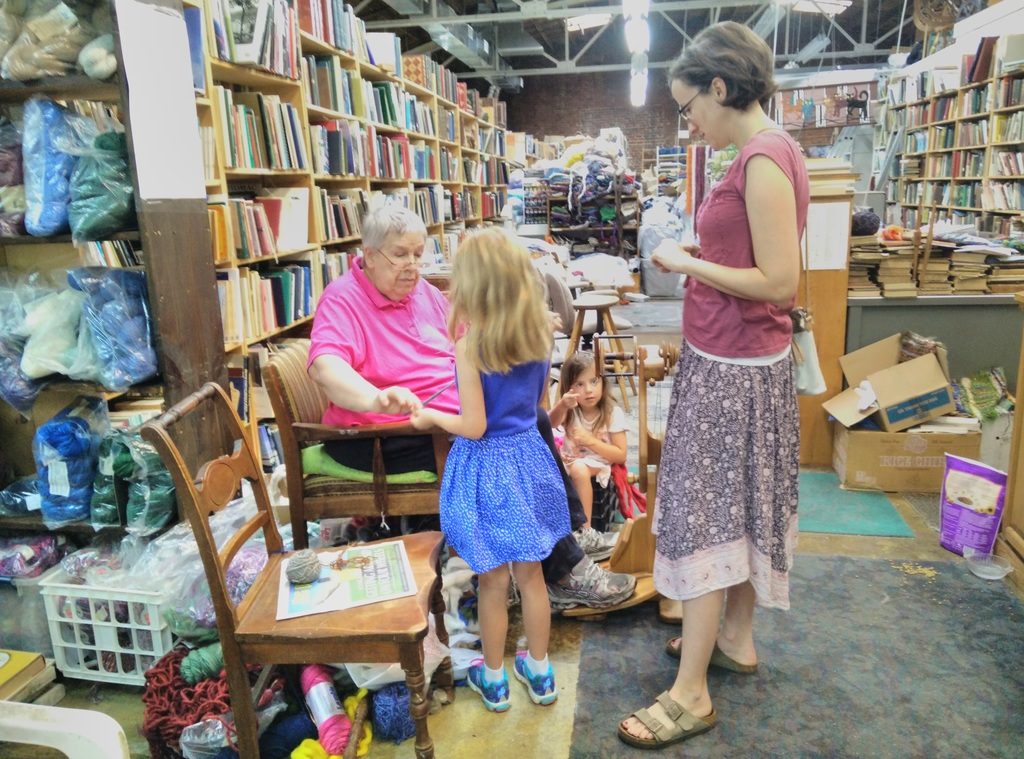 Patiently explaining how to wind yarn to the girls.